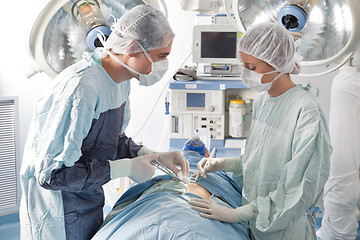 Image showing Surgeons performing operation