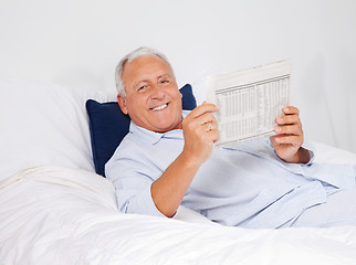 Image showing Relaxed Man Reading Newspaper