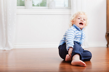 Image showing Boy sitting on the floor