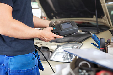 Image showing Mechanic using a Diagnostic Tool