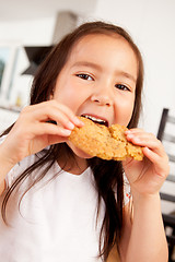 Image showing Young Girl Eating Cookie