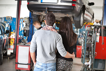 Image showing Rear view of young couple in garage