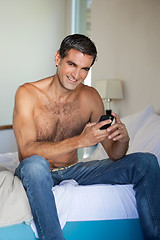 Image showing Shirtless Man Using Cell Phone