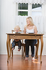 Image showing Woman and baby at dining table