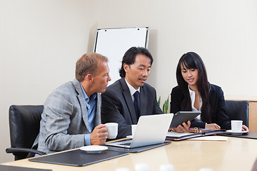 Image showing Business people using tablet in meeting