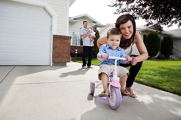 Image showing Loving Mother Teaching Son To Ride Tricycle