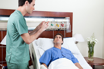 Image showing Doctor about to inject to patient