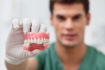 Image showing Male practitioner holding dental mold