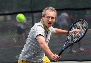 Image showing Middleage man playing tennis