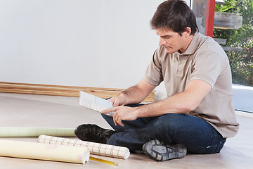 Image showing Young man looking at color sample