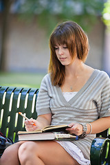 Image showing Young Student Outdoors Writing