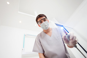 Image showing Dentist with Ultraviolet Light