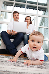 Image showing Child on Floor - Parents Using Laptop