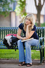 Image showing Female student sitting on bench