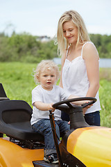 Image showing Boy Toddler Sitting on Lawn Tractor