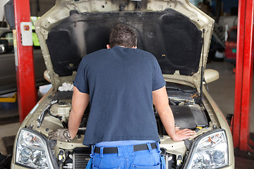 Image showing Mechanic working on a car