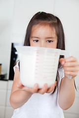 Image showing Girl with measuring Cup