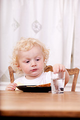 Image showing Child Sitting at Table