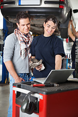 Image showing Female mechanic using laptop with client