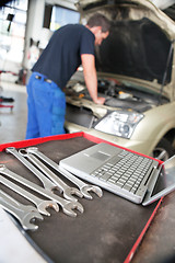 Image showing Closeup of a laptop and wrench