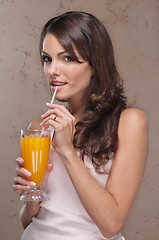 Image showing Portrait of woman drinking orange juice