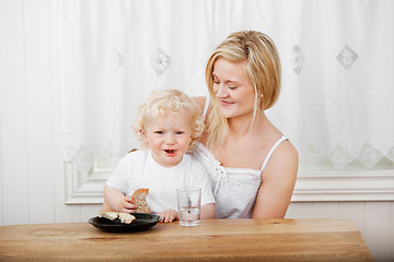 Image showing Young woman looking at baby boy