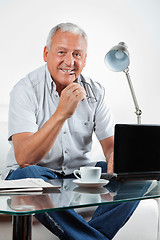 Image showing Smiling Senior Man With Laptop on Table