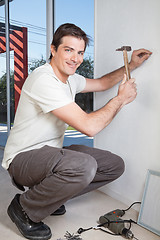 Image showing Young man with hammer