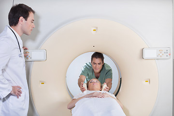 Image showing Male nurse preparing patient for CT test