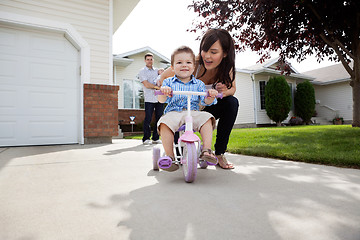 Image showing Mother Teaching Son To Ride Bike