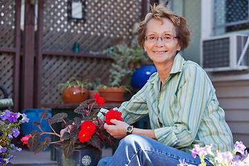 Image showing Senior woman with potted plant