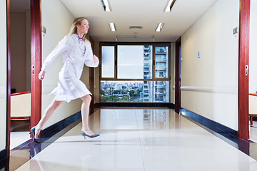 Image showing Female doctor rushing in hallway