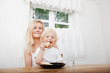 Image showing Child Eating With Mother