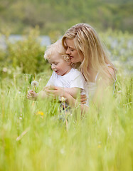 Image showing Mother and Son with Dandelion in Meadow