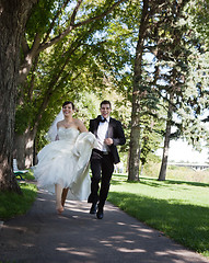 Image showing Bride and Groom Running