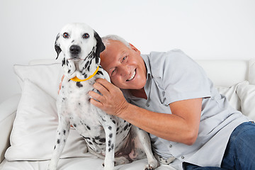 Image showing Senior Man Sitting With His Pet Dog