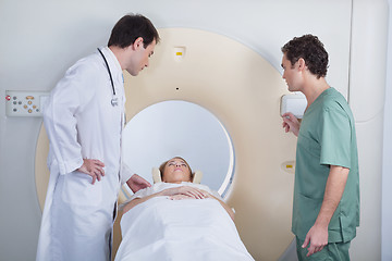 Image showing Doctor with technician examining patient