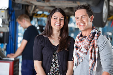 Image showing Portrait of smiling young couple in mechanic shop