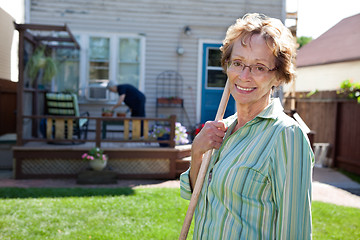 Image showing Senior Woman holding gardening tool