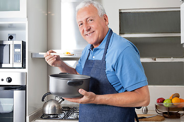 Image showing Senior Man Tasting Food