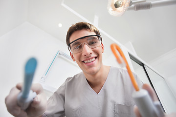 Image showing Dentist holding dental tools