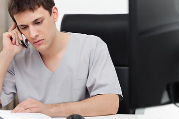 Image showing Dentist talking on phone