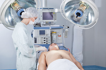 Image showing Surgeon checking patient before operation