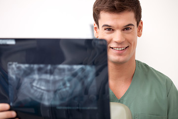Image showing Happy Smiling Man Dentist Holding X-ray