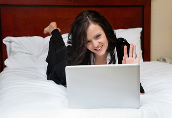 Image showing Businesswoman Lying on Bed With Laptop