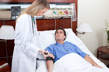 Image showing Doctor checking blood pressure of patient