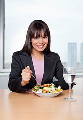 Image showing Businesswoman Eating Salad at Workplace