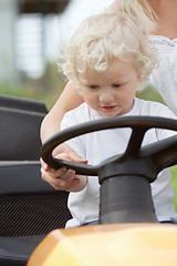 Image showing Young Boy Holding Steering Wheel