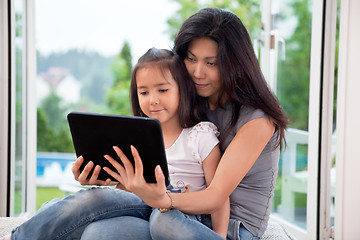 Image showing Mother and girl with E-book