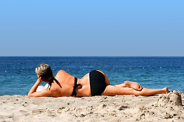 Image showing Woman relaxing on a beach